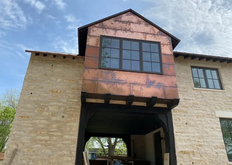 Copper metal panel facade on a stone building for Metal Roof Coating in Sioux Falls