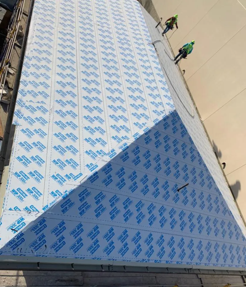 Professional roofers installing underlayment on a metal roof in Sioux Falls